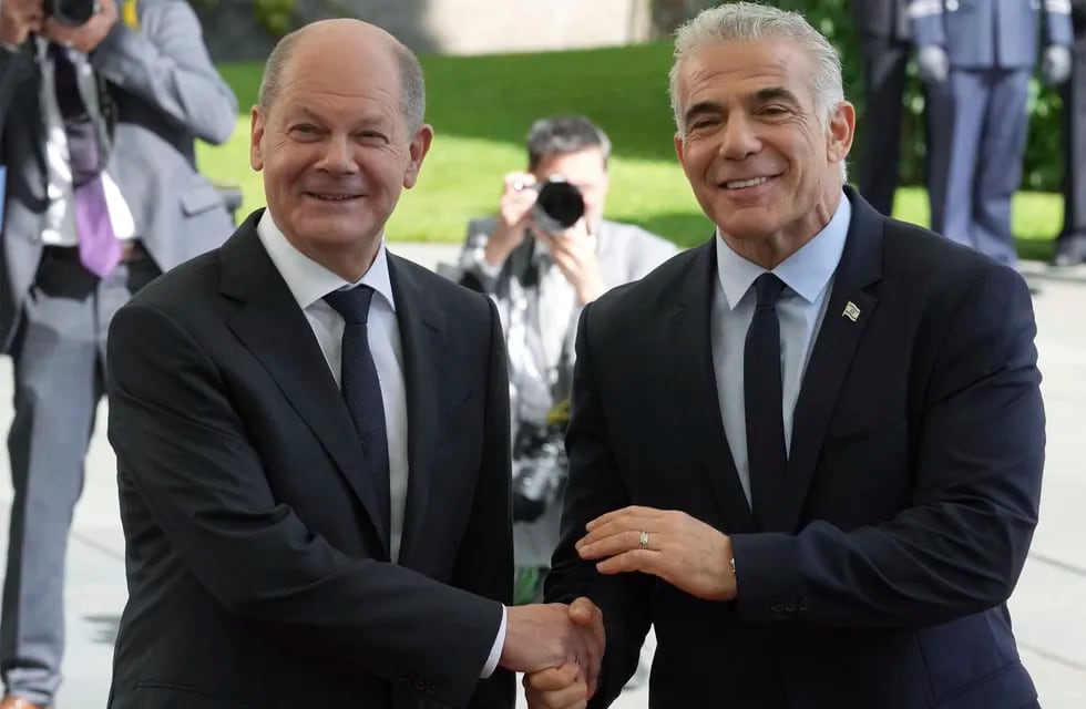 German Chancellor Olaf Scholz, left, welcomes Israeli Prime Minister Yair Lapid, right, for a meeting at the chancellery in Berlin, Germany, Monday, Sept. 12, 2022. (AP Photo/Michael Sohn)
