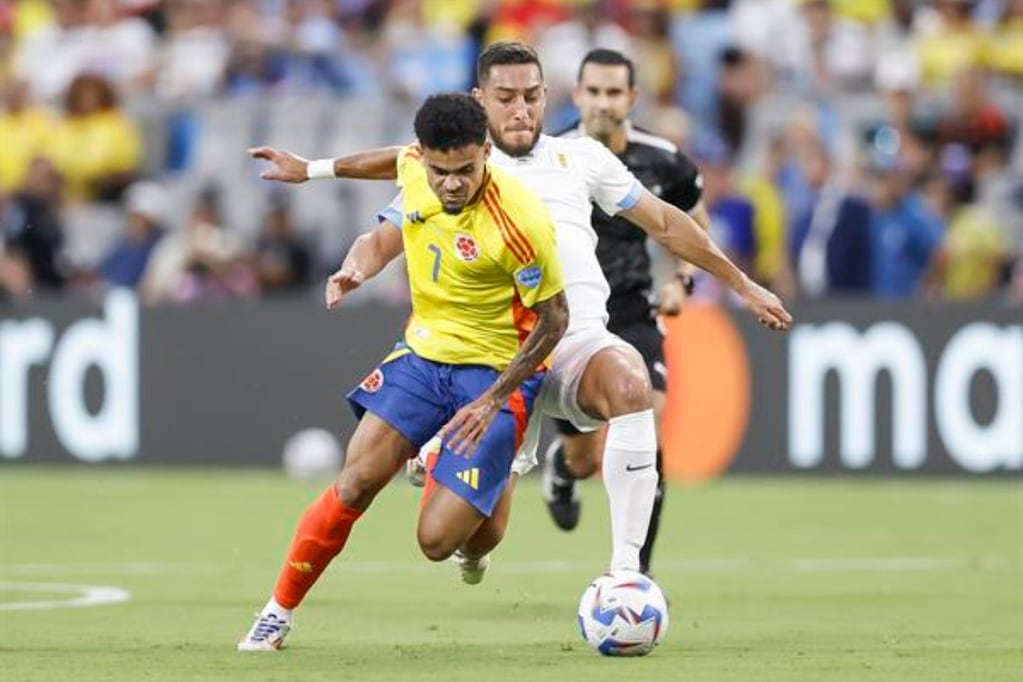 Colombia's Luis Diaz (L) and Uruguay's Sebastian Caceres (R) in action during the first half of the CONMEBOL Copa America 2024 semi-finals match between Uruguay and Colombia in Charlotte, North Carolina, USA, 10 July 2024. EFE/EPA/BRIAN WESTERHOLT