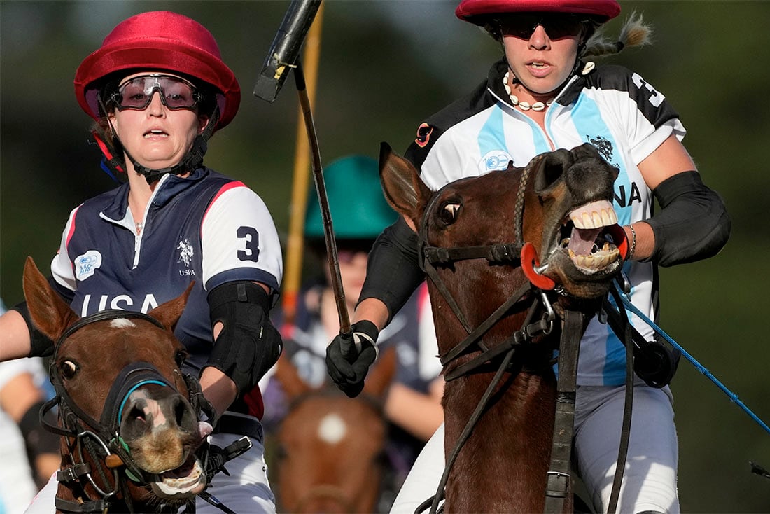 La polista estadounidense Jenna Davis (izquierda) y la argentina Catalina Laivinia compiten durante la final del Mundial de Polo femenino, en Buenos Aires, Argentina, el 16 de abril de 2022. Seis países se enfrentaron en el Campo Argentino de Polo en la primera edición de la competencia en la que Argentina se coronó campeona. (AP Foto/Natacha Pisarenko)