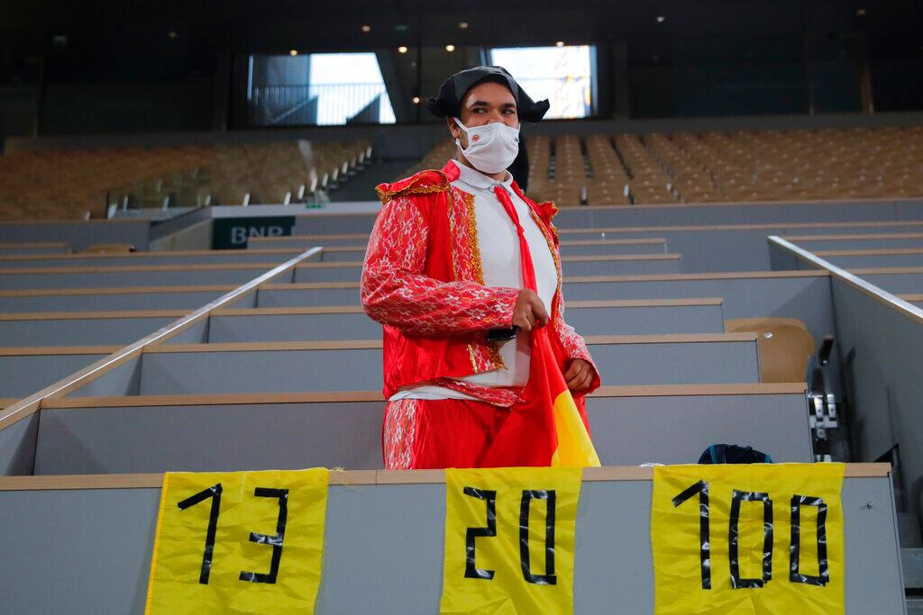 Un espectador disfrazado de torero con carteles por las 13 victorias de Nadal en Roland Garros, 20 títulos en Grand Slam y 100 partidos ganados en el abierto francés.