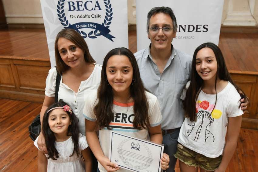 
José Gutiérrez / Los Andes | Medalla y diploma. Guillermina Vega Bellene, ganadora de la beca 2019, recibió un diploma y una medalla. Tiene 14 años, va al Colegio Compañía de María de Ciudad y fue becada con un promedio de 9.8. Estuvo en el acto junto a sus padres y sus hermanitas.
   