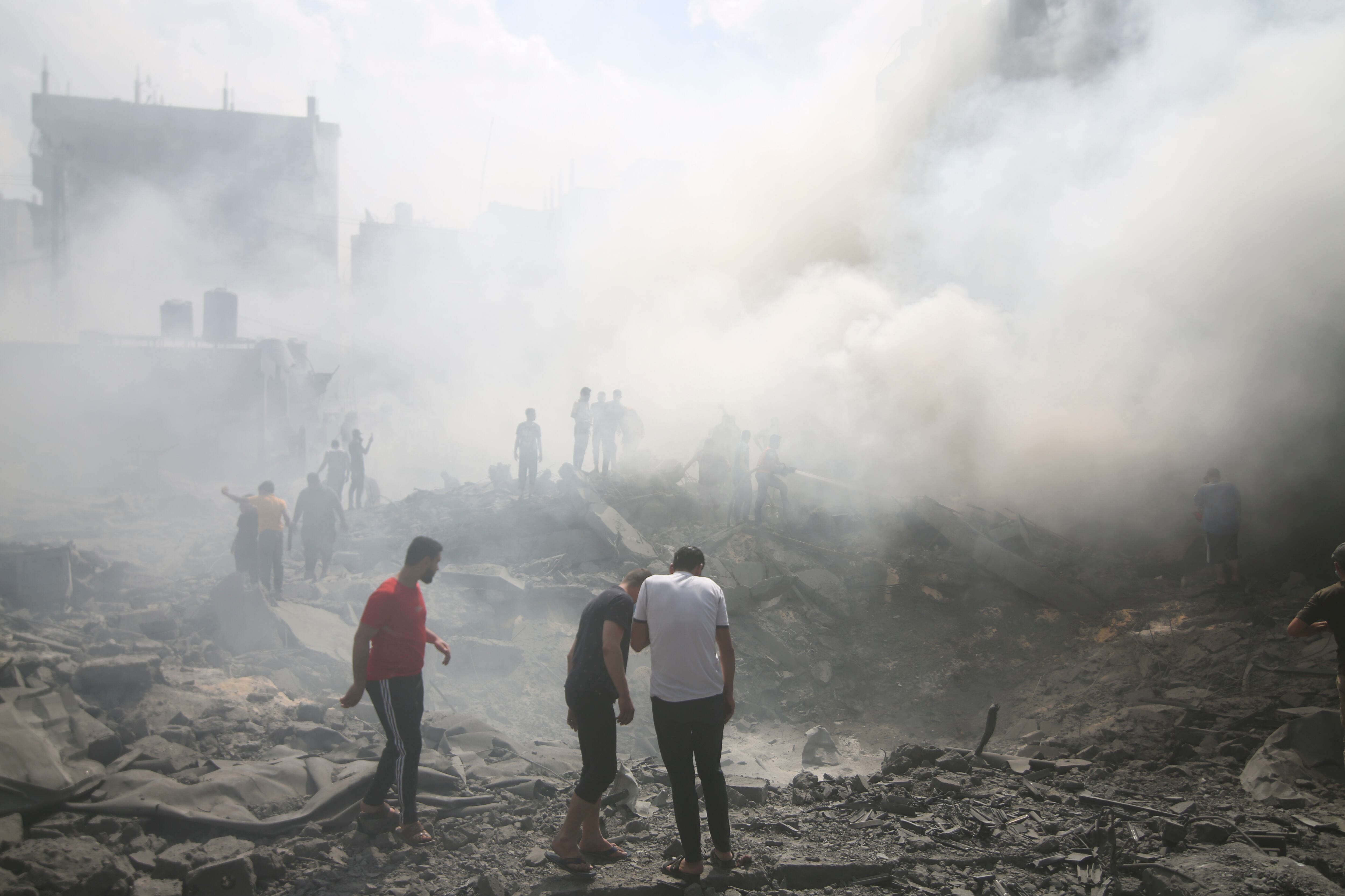 Palestinos buscan sobrevivientes luego de un ataque aéreo israelí, el jueves 12 de octubre de 2023, en el campamento de refugiados de Rafah, en el sur de la Franja de Gaza. (AP Foto/Hatem Ali)