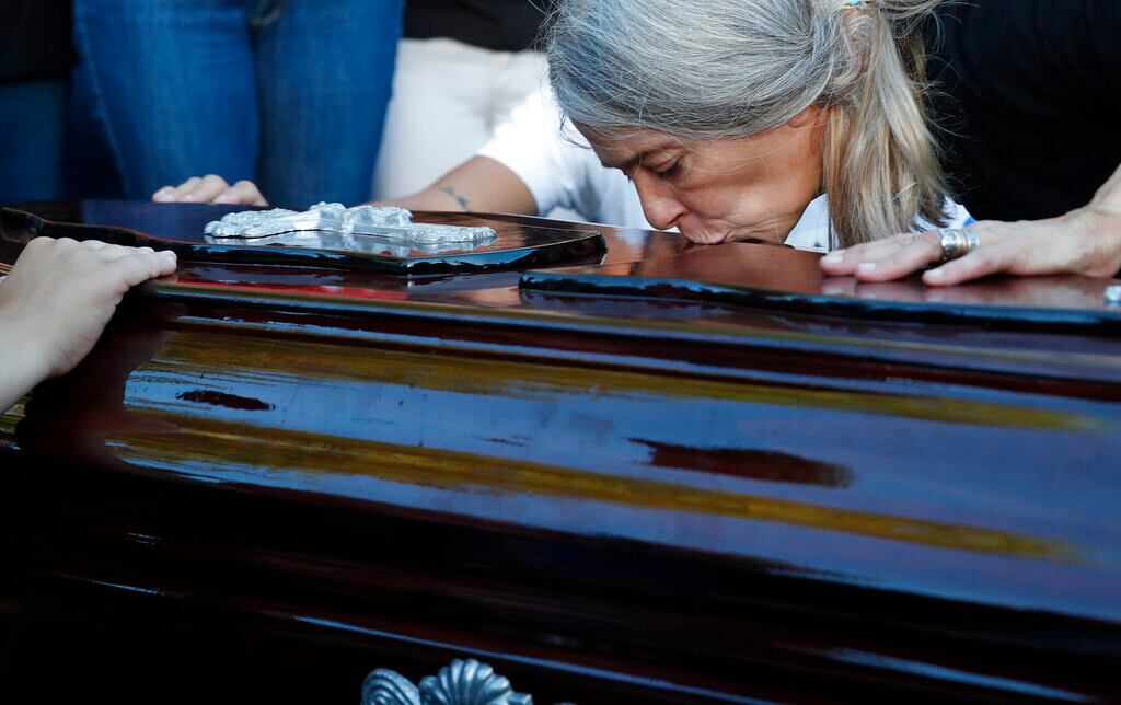 Patricia Nasutti, madre de Úrsula Bahillo, una joven de 18 años que apareció apuñalada en un campo, besa el féretro de su hija durante su entierro en Rojas, Argentina