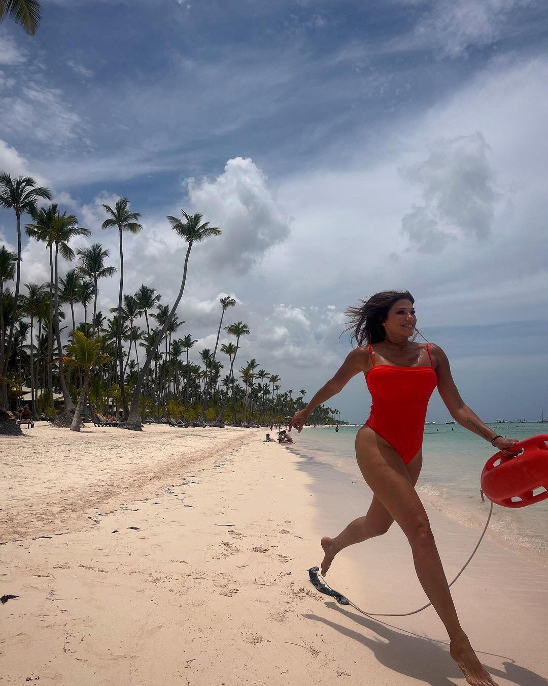 Catherine Fulop divertida en la playa.