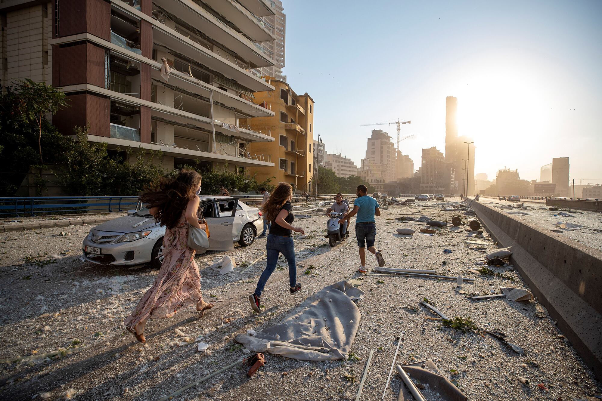 Habitantes de Beirut corren por las calles devastadas después de la gran explosión que afectó al puerto de la ciudad.