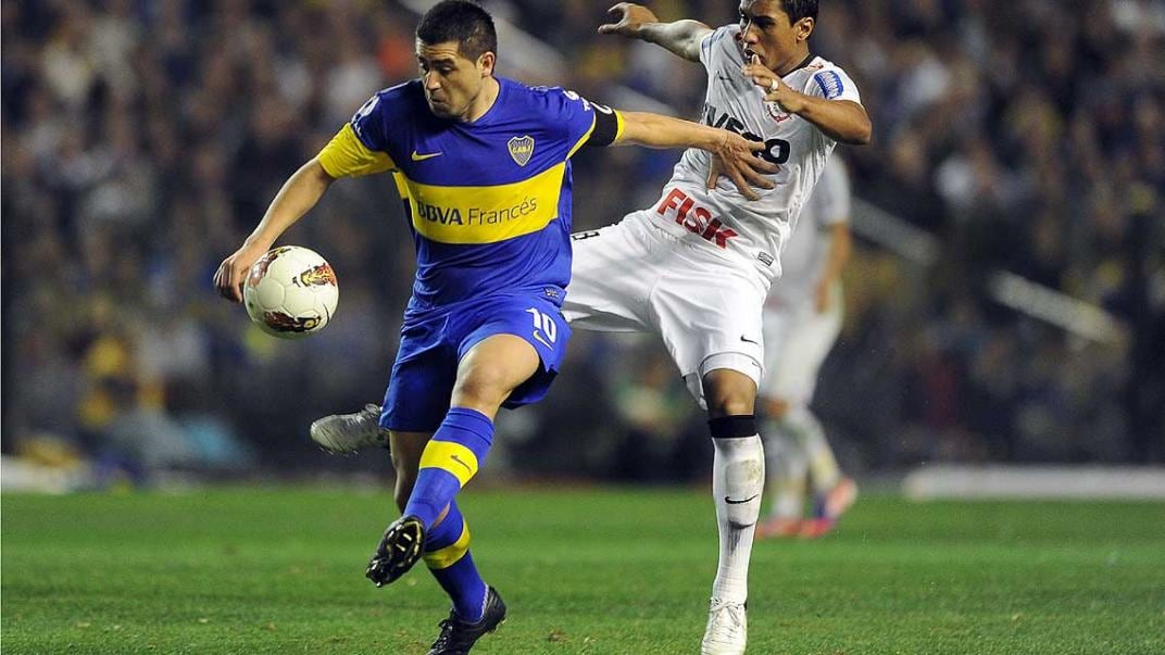 Riquelme intenta llevarse la pelota ante la marca de un jugador de Corinthians (Foto: Télam).