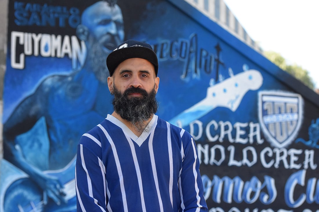 El bajista Diego Aput posó junto a la obra artística que le dedicaron en Godoy Cruz. / 