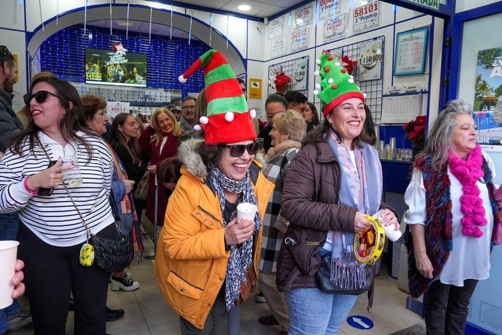 Premiados y vecinos celebran el segundo premio del sorteo extraordinario de la lotería de Navidad caído en la administración número 1 de Chipiona, Cádiz. Foto: EFE